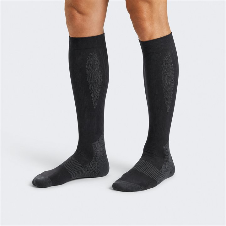 Schwarze kniehohe Running-Kompressionssocken mit Strickzonen als Symbolbild